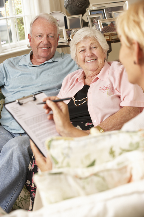 Elderly couple talking to a asset protection lawyer